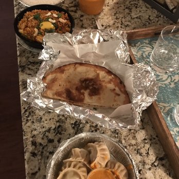 Curry House - Bottom to top: Chicken MoMo (favorite!), garlic naan (yum), Shrimp Biryani (spicy but really good!) and chicken Curry (delicious) - Indian Near Me - Wake Forest, North Carolina