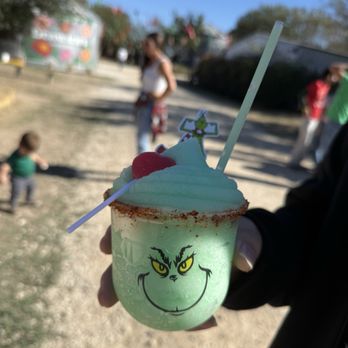 Devine Acres Farm - A frozen Grinch-arita topped w/ a lollipop, lined w/ tajin, & topped w/ The Grinch character topper to match pair w/ the sangria - Amusement Parks Near Me - Devine, Texas Devine Acres Farm - A frozen Grinch-arita topped w/ a lollipop, lined w/ tajin, & topped w/ The Grinch character topper to match pair w/ the sangria - Amusement Parks Near Me - Devine, Texas