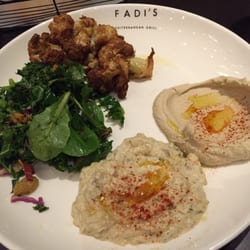 Fadi's Mediterranean Grill - Sugar Land - Sides, clockwise from top: cauliflower, traditional hummus, baba ghanoush, kale salad