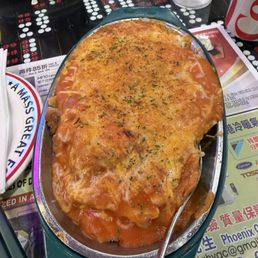 Baked chicken over tomato sauce and cheese