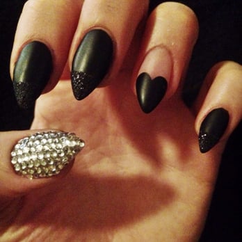Bridgeport Nails - Matte black stilettos with black sparkles, a heart shape on ring fingers, and crystals on thumbs! By Joanne - Skin Care Near Me - Tigard, Oregon