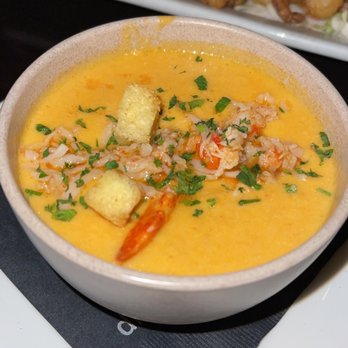 C Level - Island prime's lobster bisque with crispy calamari in the back - New American Near Me - San Diego, California
