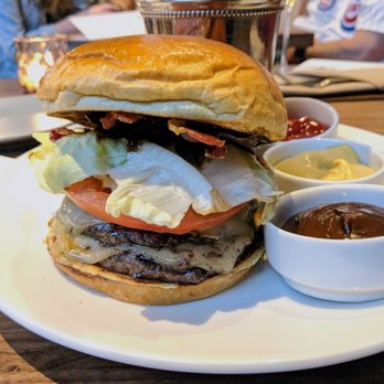 Mordecai - Mordecai Burger - bacon, double 1/4 Slagel beef patties, smoked gruyere, heirloom tomato, lettuce, pickle, black garlic aioli - New American Near Me - Chicago, Illinois