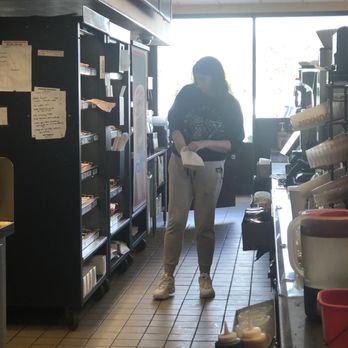 Dunkin' -  a woman standing in a kitchen - Coffee & Tea Near Me - Plainview, New York