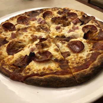 Pepper Mill Cafe - a pepperoni pizza on a white plate - Hotels Near Me - Winnipeg, Manitoba Pepper Mill Cafe - a pepperoni pizza on a white plate - Hotels Near Me - Winnipeg, Manitoba