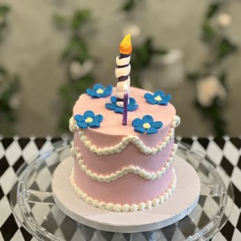 The Cakes Nest - a birthday cake with a lit candle - Bakeries Near Me - Rocklin, California The Cakes Nest - a birthday cake with a lit candle - Bakeries Near Me - Rocklin, California