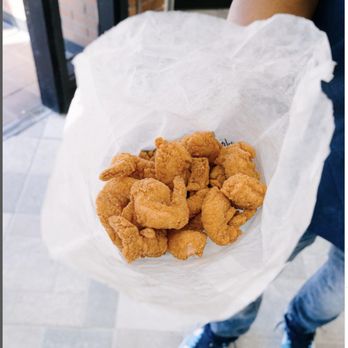 Shrimp Island - a person holding a bag of fried shrimp - Seafood Near Me - Chicago, Illinois Shrimp Island - a person holding a bag of fried shrimp - Seafood Near Me - Chicago, Illinois