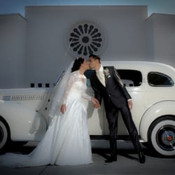 Lake Forest Limousines - Wedding couple at St.Edwards Church Dana Point in front of 1939 American Rolls Royce Packard by Lake Forest Limos