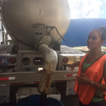 Cruzan Rum Distillery - That black is not a hose! It's thick molasses being pumped out of the truck andand into the distilleries. - Tours Near Me - St Croix, Virgin Islands