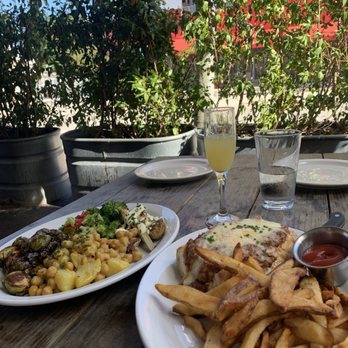 Blue Collar - Outdoor seating area with both meals and a refreshing mimosa! - Comfort Food Near Me - Miami, Florida Blue Collar - Outdoor seating area with both meals and a refreshing mimosa! - Comfort Food Near Me - Miami, Florida