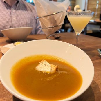 Woodlands American Grill - a bowl of soup and a glass of orange juice - American Near Me - Dallas, Texas