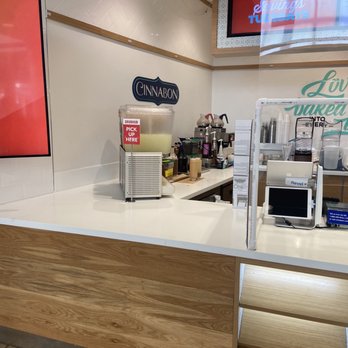 Cinnabon - a coffee shop counter with a coffee machine - Bakeries Near Me - Greensboro, North Carolina