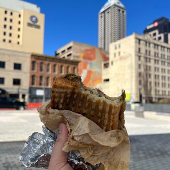 Subito - a hand holding a piece of food - Soup Near Me - Indianapolis, Indiana