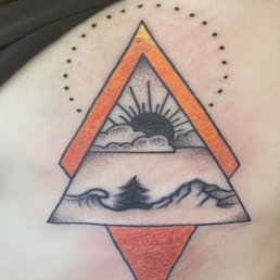 Originally was just a simple line design of a wave, tree, and mountain. She added more details to them.