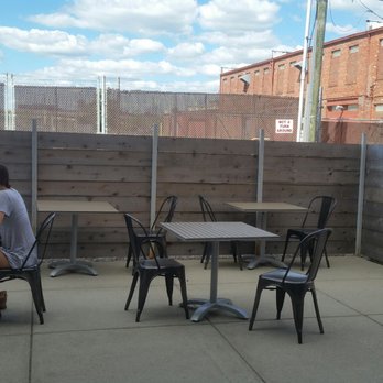 Quills Coffee - Patio is small with a fence panel blocking view of vehicles coming and going along 9th Street. - Coffee & Tea Near Me - Indianapolis, Indiana