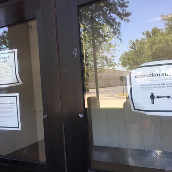 CubeSmart Self Storage - messaging on the doors - The glass door features printed signs with instructions on mask-wearing and social distancing, including maintaining 6 feet distance. - Self Storage Near Me - Miramar, Florida