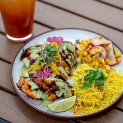 Indicana - Achiote marinated pollo asado, served with a turmeric pulao rice and a corn- radish salad in a curry leaf vinaigrette.