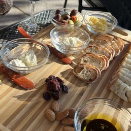 a table with wine, bread, and cheese a table with wine, bread, and cheese