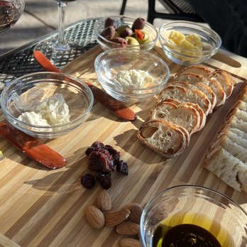 Walport Family Cellars - a table with wine, bread, and cheese - Wineries Near Me - Grants Pass, Oregon Walport Family Cellars - a table with wine, bread, and cheese - Wineries Near Me - Grants Pass, Oregon