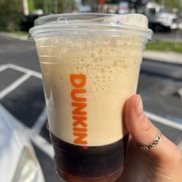 a hand holding a cup of coffee a hand holding a cup of coffee
