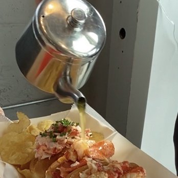 Bite Into Maine - Butter being poured on the lobster rolls. - Seafood Near Me - Portland, Maine