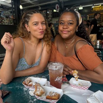 Loretta's Authentic Pralines - Me and D enjoying beignet - Candy Stores Near Me - New Orleans, Louisiana
