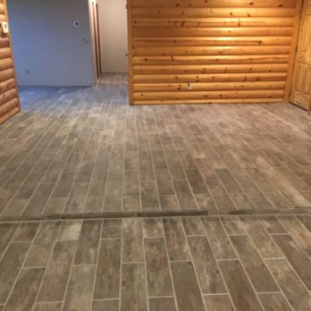 CHS Remodeling - a log cabin with a wood floor - Painters Near Me CHS Remodeling - a log cabin with a wood floor - Painters Near Me