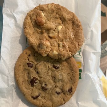 Subway - a hand holding two chocolate chip cookies - Sandwiches Near Me - Palm Bay, Florida Subway - a hand holding two chocolate chip cookies - Sandwiches Near Me - Palm Bay, Florida