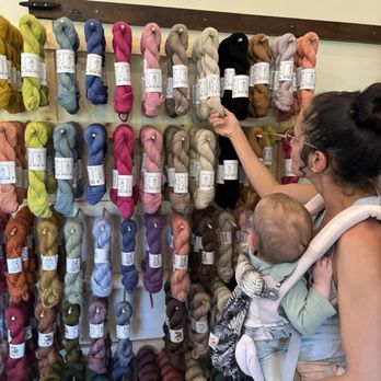 Stitch by Stitch - Juicy wall of Ritual dyes yarn and Farmers Daughter Fibers even the baby wants to see! - Florists Near Me - Wailuku, Hawaii Stitch by Stitch - Juicy wall of Ritual dyes yarn and Farmers Daughter Fibers even the baby wants to see! - Florists Near Me - Wailuku, Hawaii