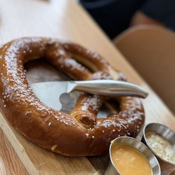 Orchard - Pretzel with cheese sauce and stone ground mustard that wasn't too spicy. Served on charcuterie board with cheese knife. Clever! - Cideries Near Me - Verona, Wisconsin