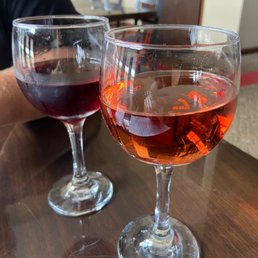 two glasses of wine on a table two glasses of wine on a table