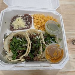 Delicias Catrachas - Tacos Mexicanas asada. Green salsa is "hot", orange is "mild".