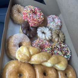 A dozen assorted baked donuts A dozen assorted baked donuts