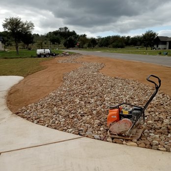 Kaius Irrigation and Construction - a man using a machine on a gravel driveway - Irrigation Near Me Kaius Irrigation and Construction - a man using a machine on a gravel driveway - Irrigation Near Me