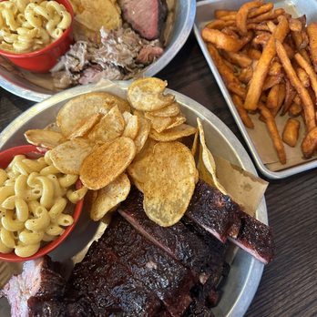 Lulu's BBQ - Fatty Brisket + Pulled pork (top), sweet potato fries (right) full rack of ribs (bottom) - Barbeque Near Me - Louisville, Colorado Lulu's BBQ - Fatty Brisket + Pulled pork (top), sweet potato fries (right) full rack of ribs (bottom) - Barbeque Near Me - Louisville, Colorado