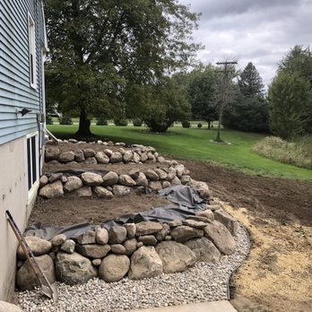 Blooms Landcare - a rock wall being built in front of a house - Landscaping Near Me - Chelsea, Michigan Blooms Landcare - a rock wall being built in front of a house - Landscaping Near Me - Chelsea, Michigan