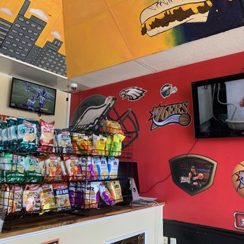 The Philly Cheesesteak Cafe - a television and a wall of food - Cheesesteaks Near Me - Chesapeake, Virginia The Philly Cheesesteak Cafe - a television and a wall of food - Cheesesteaks Near Me - Chesapeake, Virginia