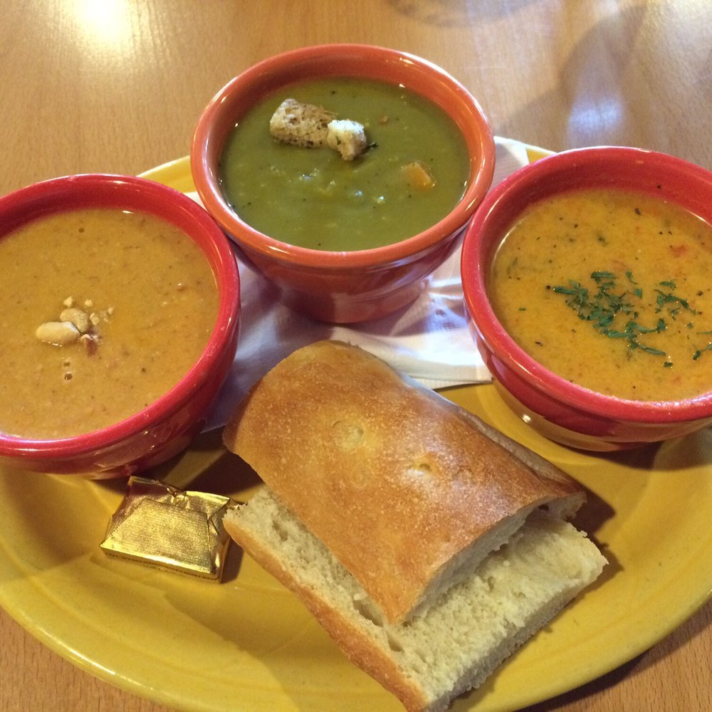 Colophon Cafe - Soup Sampler. From left to right: African Peanut, Split Pea, Curry Carrot and Rice (soup de jour). Fresh baguette. - Salad Near Me - Bellingham, Washington