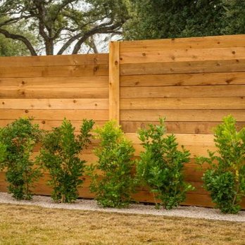 Zavaleta Gutter Cleaning - a fence with a row of trees - Gutter Services Near Me