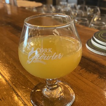 Cork & Growler - a glass of beer on a bar - Wine Bars Near Me - Frisco, Texas