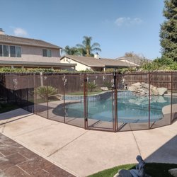 Valley Pool Guard - Recent 5 foot brown fence for a client, optimizing space for gathering outside the fenced area.