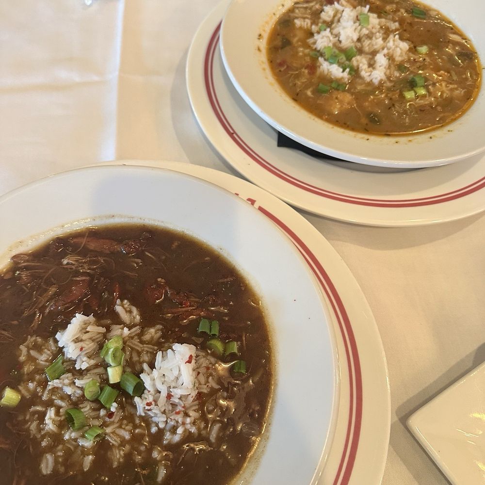 Rouj Creole - CUP OF DUCK ANDOUILLE GOMBO (dark roux) and CUP OF SEAFOOD GOMBO (light roux) - Cajun/Creole Near Me - Baton Rouge, Louisiana Rouj Creole - CUP OF DUCK ANDOUILLE GOMBO (dark roux) and CUP OF SEAFOOD GOMBO (light roux) - Cajun/Creole Near Me - Baton Rouge, Louisiana