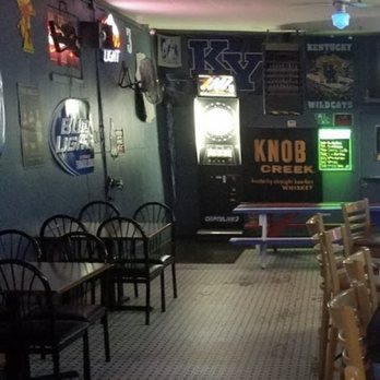 The Deuce - a man sitting at a table in a restaurant - Dive Bars Near Me - Louisville, Kentucky