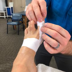 STI Physical Therapy & Rehabilitation - Doctor is expertly taping my left foot