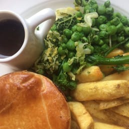 Steak pie, chips and seasonal veggies.