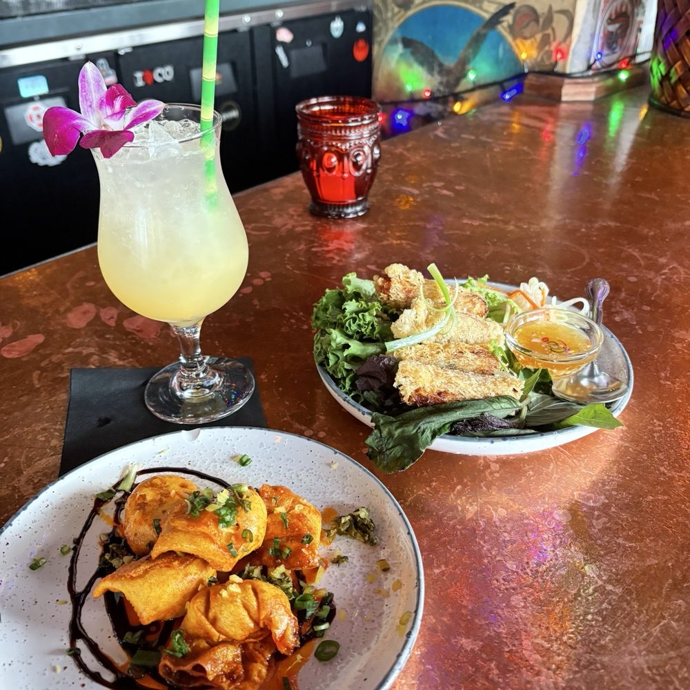 Happy hour items: Shanghai Spicy Wontons (front), Passion & Fizz (drink), Cha Gio Re (back)