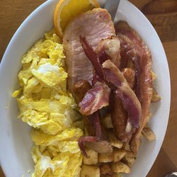 Mom's Restaurant - eggs, bacon, home fries, canadian bacon, an orange slice.