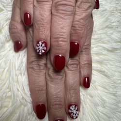 Sns dip Ken did clear on my mom's hands and red gel polish and hand drew her designs and poured white glitter over.