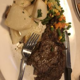 Grilled rib eye steak with roasted potatoes and mixed veggies