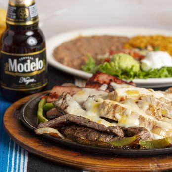 Los Hermanos Mexican Restaurant - Parrillada Mix - grilled beef & chicken fajita & smoked sausage, topped with Monterrey & American cheese. - Mexican Near Me - Terrell, Texas Los Hermanos Mexican Restaurant - Parrillada Mix - grilled beef & chicken fajita & smoked sausage, topped with Monterrey & American cheese. - Mexican Near Me - Terrell, Texas